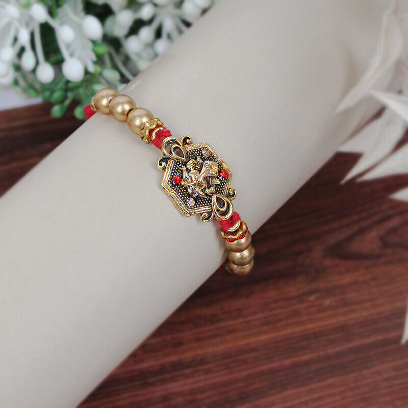 

Madhoor H-16 Gold Ganesh Rakhi Design